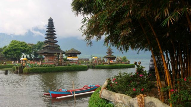Bratan temple and lake with typical Balinese Meru towers and a boat, central Bali 
