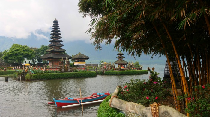 Bratan temple and lake with typical Balinese Meru towers and a boat central Bali indonesia 