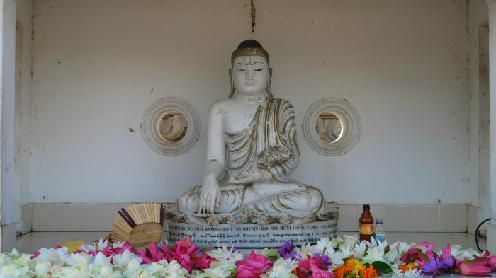 A small white Buddha statue on the altar in Ruwanvelisaya stupa in Anuradhapura in Sri Lanka 