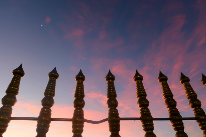pink sunset sky, the moon and the fence of the sri pada temple in sri lanka 