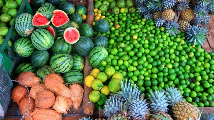 watermelons, coconuts, pineapples and limes -tropical exotic fruit in the local market in Kandy in Sri Lanka 