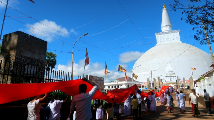 Locals during a ritual at the Ruwanvelisaya stupa in Anuradhapura in Sri Lanka 