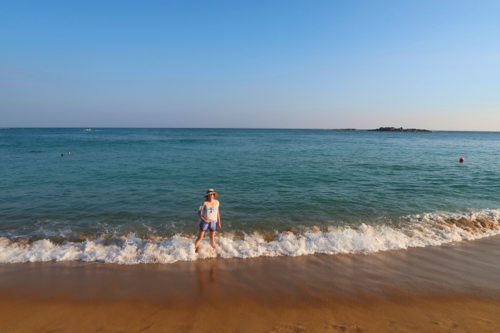 a girl enjoying the waves on the beach in unawatuna sri lanka 