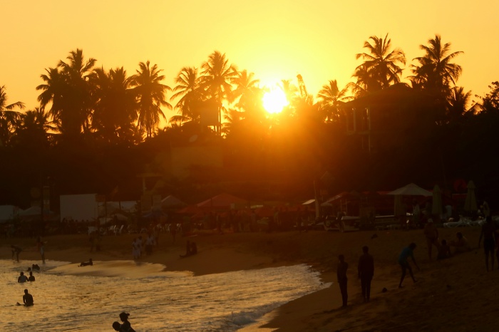 orange sunset and palm trees on the beach in unawatuna sri lanka 