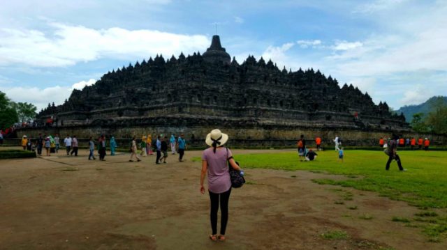 a girl looking at the borobudur temple in java indonesia 