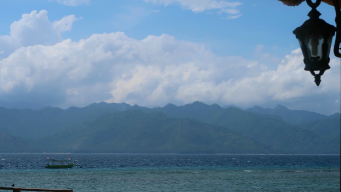 blue sea and sky with islands in the background on a sunny morning in gili trawangan indonesia
