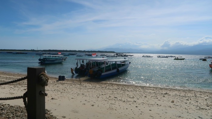 sandy beach and traditinional boats on a sunny day in gili trawangan indonesia