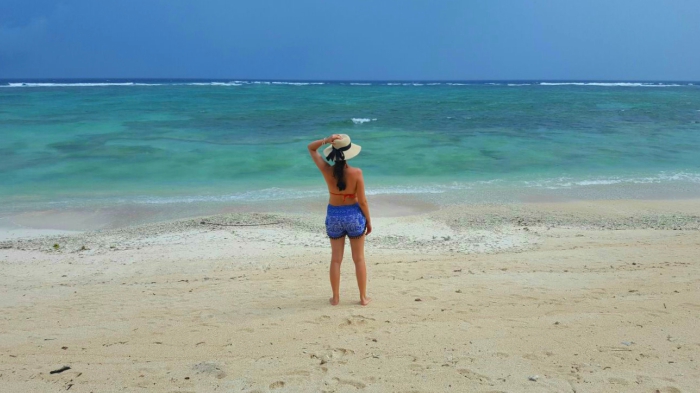a girl looking at the indian ocean on a paradise sandy beach in gili trawangan indonesia 