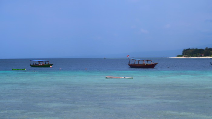 turquoise blue sea and sky and traditional boats in gili trawangan indonesia