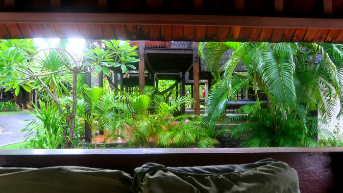 a wooden cottage for meditation and green palm trees and plants in vila ombak resort in gili trawangan indonesia 