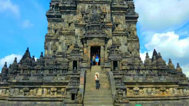 girl standing on the stairway to the entrance of prambanan temple in java indonesia 