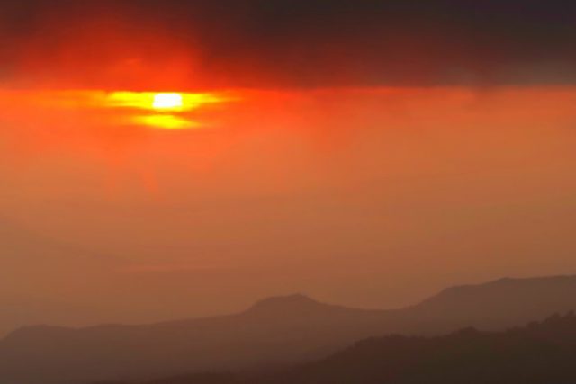 orange sunrise on a foggy morning above the bromo volcano in java indonesia 