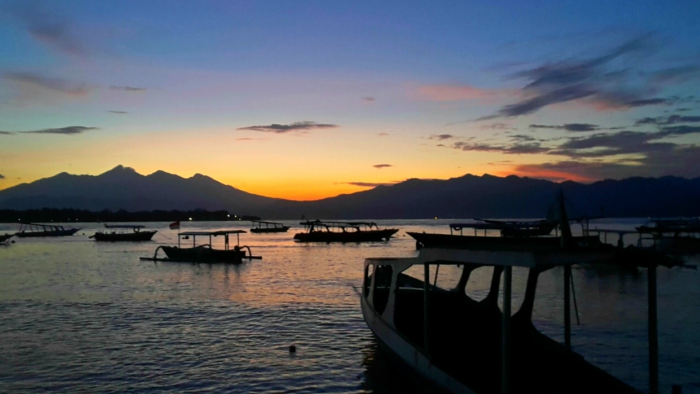 sunrise sky and traditional boats in the sea in gili trawangan indonesia