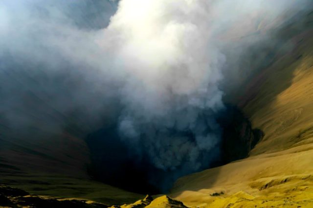 smoke coming out of an active volcano crater - bromo volcano in java indonesia 