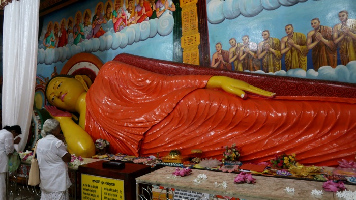 reclining buddha statue inside of the small temple in front of the abayagiriya stupa in the ancient city of anuradhapura in sri lanka 