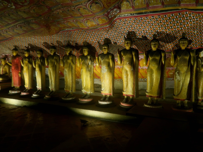 standing buddha statues inside of Dambulla golden cave temple in sri lanka 